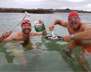 2 males in the sea pretending to cook